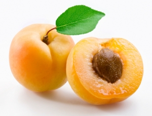 Apricots with leaves on a white background.